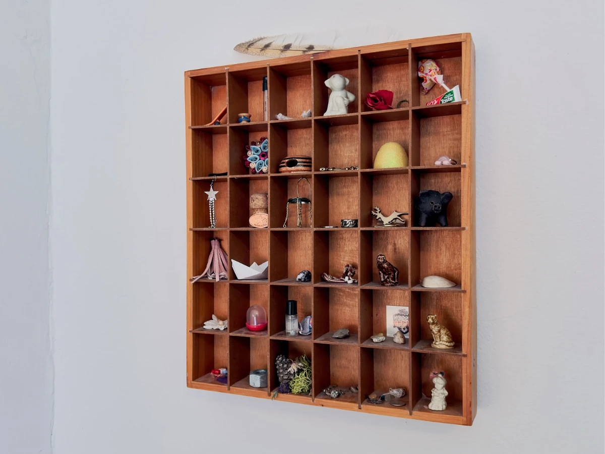 Multi-cubby wood wall hanging with small knick-knacks in Room 202 at Hot Lake Springs Resort.