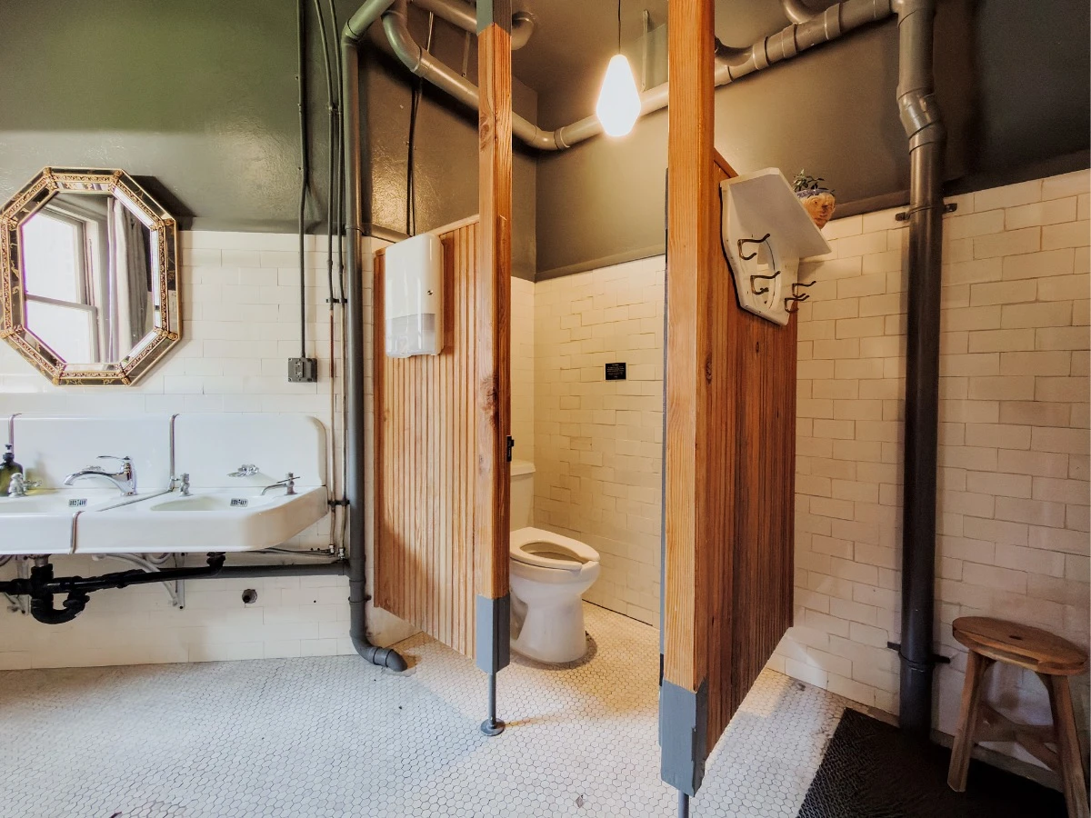 Private toilet stall in shared bathroom at Hot Lake Springs Resort.